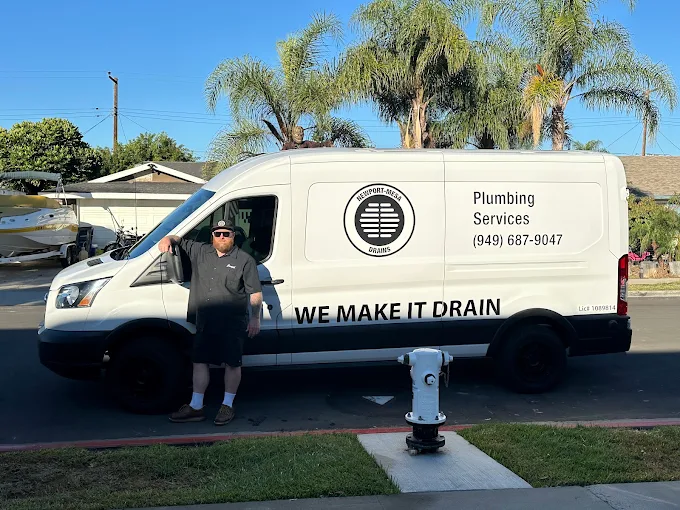 Joseph Russell standing beside the Newport-Mesa Drains work van